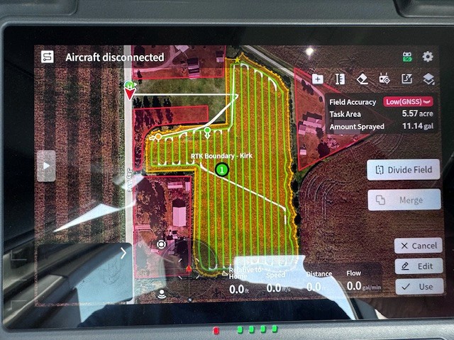 Flight plan on the controller showing field boundary, spray path, and obstacle offsets